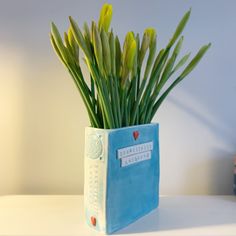 there is a blue book with flowers in it