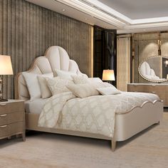 a large white bed sitting in a bedroom next to a night stand and two lamps