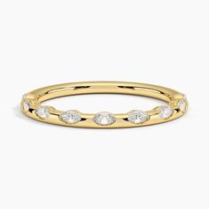 a yellow gold ring with five diamonds