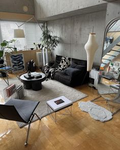 a living room filled with lots of furniture and a large mirror on the wall above it