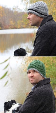 a man sitting next to a lake holding a black and white dog