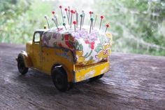 an old toy truck with needles in the back