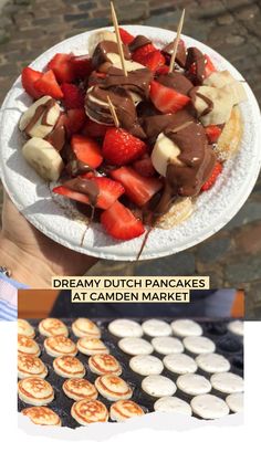 a person holding a plate with strawberries and bananas on it next to other desserts