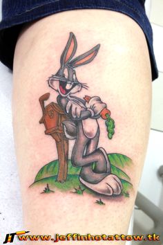 a rabbit with carrots on his leg