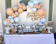 a baby shower party with balloons and teddy bears on the front table, along with other decorations