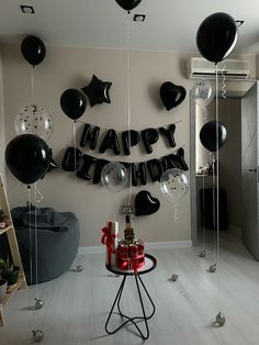 a birthday party with black and silver balloons