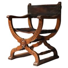 an old wooden chair with leather straps