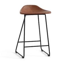 a brown leather stool with black metal legs