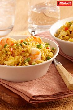 two white bowls filled with rice and shrimp