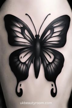 a black butterfly tattoo on the back of a woman