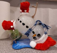 a snowman balloon sitting on top of a counter next to a toilet paper roll