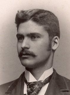 an old black and white photo of a man with a mustache