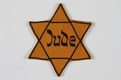 an orange and black star of david with the word surj written in arabic on it