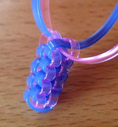 a purple and blue necklace on a wooden table