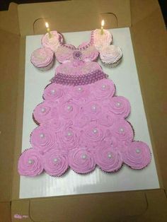 a box with cupcakes in the shape of a princess dress