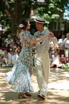 a man and woman dancing in front of an audience