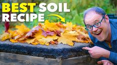 an older man pointing at leaves in a wooden box with the words best soil recipe on it