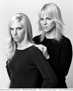 two women standing next to each other in black and white