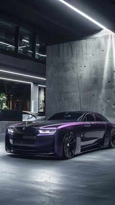 a purple car is parked in front of a large concrete wall with lights on it