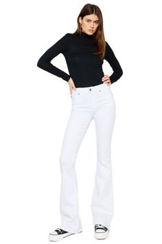 Our Alaska Mid Rise Jeans come in a classic flare cut in an opulent white color that was made to stand out. Sits right at the natural waistline as it gently tapers down the leg and begins to flare out at the calf. Made with super-stretch denim that keeps you feeling comfortable all day and won't bag out after each wear. Features a classic five-pocket design, single-button front, and zip-fly closure. 9" Rise   / 33.75" Inseam 66.5% Cotton, 31.3% Rayon, 2.2% Spandex Model in size 3/25 Style # : KC White Stretch Flare Jeans, White Wide Leg Flares For Spring, Chic White Stretch Flare Jeans, White Flare Fitted Jeans, Chic Fitted White Flares, Chic White Fitted Flares, White Chic Wide Leg Flares, Chic White Wide Leg Flares, Chic White Wide-leg Flares