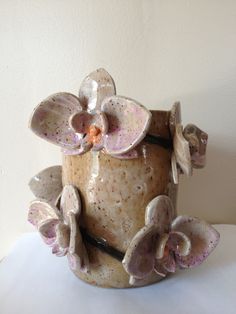 a ceramic flower pot sitting on top of a table