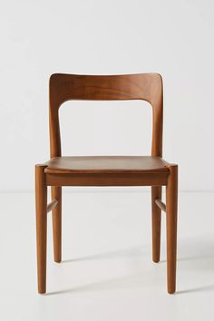 a wooden chair sitting on top of a white floor