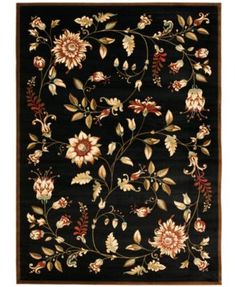 a black rug with flowers and leaves on it