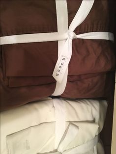 three folded brown and white sheets stacked on top of each other