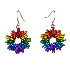 a pair of earrings with colorful beads hanging from it's earwires on a white background