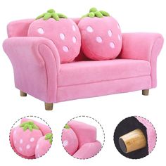 a pink couch with two strawberry pillows on it