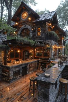 an outdoor bar is lit up at night with lights on the outside and wood flooring