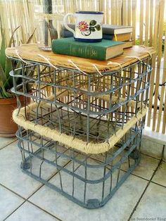 a table that has some books on it and a cup sitting on top of it