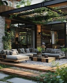 an outdoor living area with couches and tables