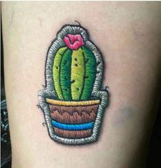 a cactus in a pot tattoo on the leg