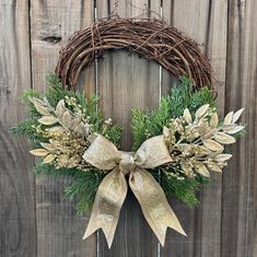 a wreath on a wooden fence with a bow