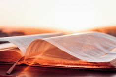 an open book sitting on top of a wooden table