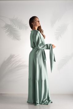 "Introducing our exquisite Mint Satin Abaya Dress, a luxurious blend of elegance and opulence. This enchanting garment features a lustrous mint satin fabric that drapes gracefully, exuding an air of sophistication and extravagance. The highlight of this abaya is its mesmerizing sleeve design, adorned with intricate embellishments and a unique silhouette that captivates all who lay eyes on it. Embrace the allure of timeless fashion with this statement piece, perfect for special occasions and crea Luxury V-neck Maxi Dress For Wedding, Elegant Satin Dress For Ceremony, Elegant Satin Maxi Abaya, Elegant Floor-length Evening Dress For Ceremony, Luxury Floor-length Maxi Dress For Wedding, Silk Maxi Dress For Wedding, Floor-length Satin Dresses For Ceremony, Luxury Long Sleeve Maxi Dress For Wedding, Elegant Long Silk Wedding Dress