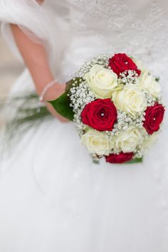 a bridal bouquet with red and white roses