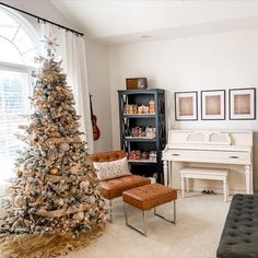 a living room filled with furniture and a christmas tree