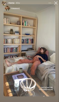 two women sitting on couches in front of bookshelves