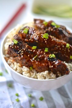 a white bowl filled with meat and rice