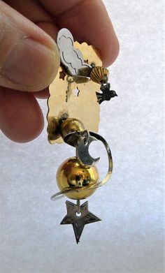 "A fantastic artsy Futuristic kinetic art pin with themes of Earth, Moon Galaxy in gold and silver metal. The gold ball is suspended on soldered wire with a silver ring and moon dangling around it. There is a cloud and bird with cut out stars. Very special and unique artisan pin. In great vintage condition. Measures 2 3/4\" long x 1 1/2\" wide x 3/4\" depth. Very Treky I will ship this item within one business day of receiving payment. Thank you. Enjoy For more Vintage Jewelry see my listings he Unique Gold Pendant Brooches, Kinetic Jewelry, Moon Galaxy, Arm Bracelets Upper, Gold Galaxy, Coil Bracelet, Mixed Media Jewelry, Kinetic Art, Contemporary Modern Art