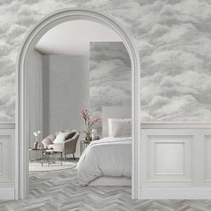 a bedroom with a bed, chair and wallpaper that has clouds painted on it