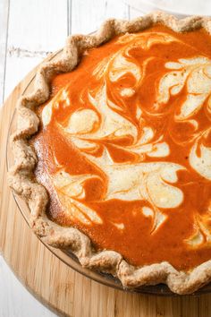 a pie sitting on top of a wooden cutting board