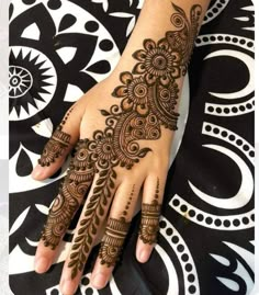 a henna tattoo on the hand of a woman