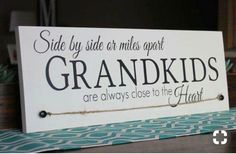 a sign that says side by side or miles apart grandkids are always close to the heart