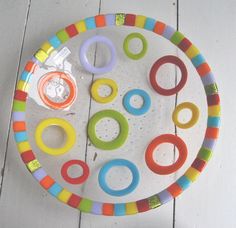 a colorful toy tray with rings on it