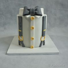 a cake that is shaped like a box with a bow tie on the front and sides