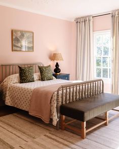 a bed sitting in a bedroom next to a window