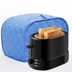 a toaster with two pieces of bread in it and a blue bag behind it